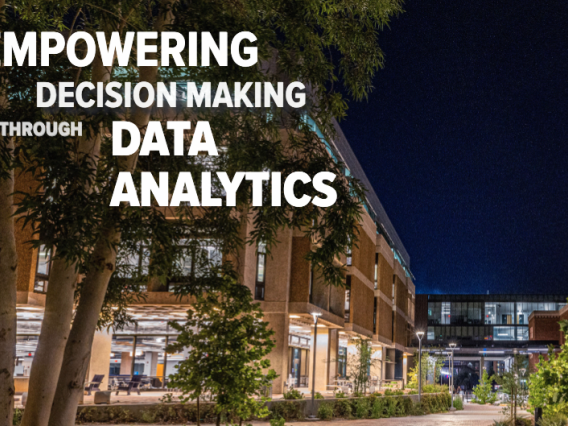 A photo of campus at night with the text 'Empowering Decision Making through Data Analytics' overlaid on the photo