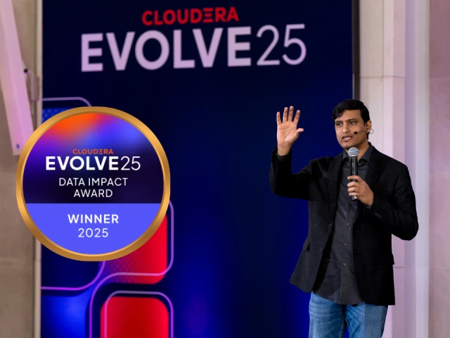 Shiva Chidara on stage at EVOLVE25 with the Data Impact Award Winner emblem
