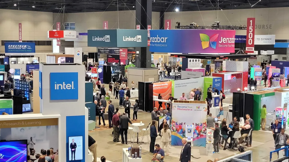 Educause 2023 Conference attendees gathered in a conference hall exploring various IT and higher ed booths