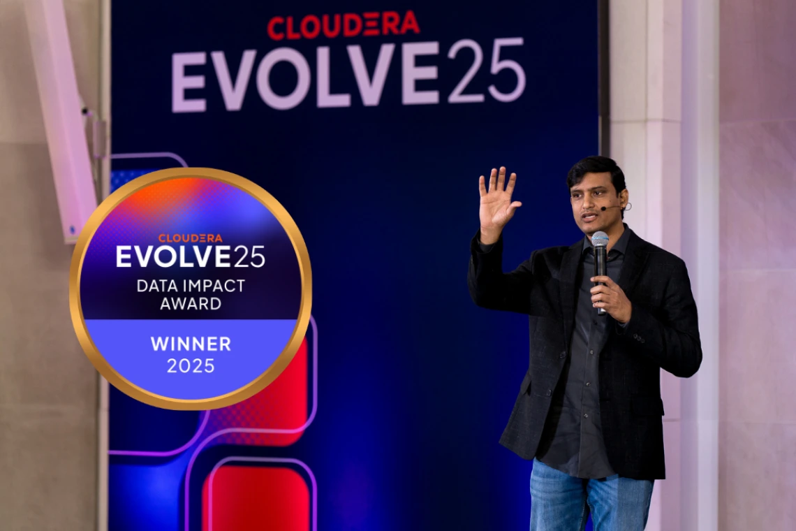 Shiva Chidara on stage at EVOLVE25 with the Data Impact Award Winner emblem